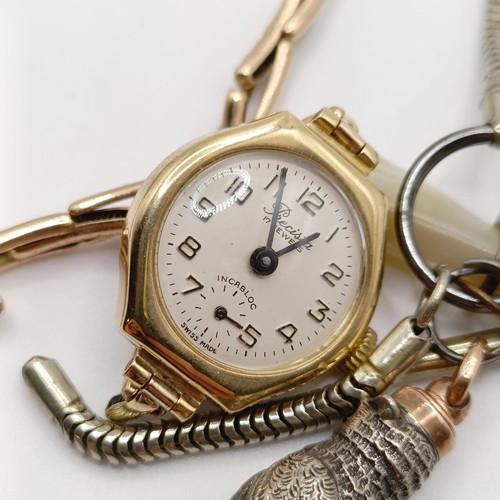 846 - A ladies 9ct gold wristwatch, a charm, a novelty whistle, in the form of an owl, on a silver plated ... 