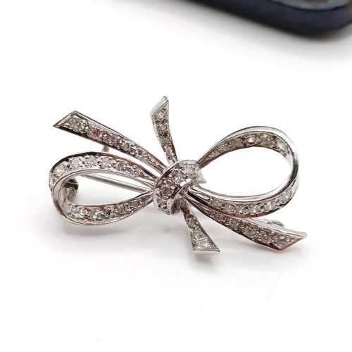 835 - An 18ct white gold and diamond bow brooch, in a vintage jewellery box