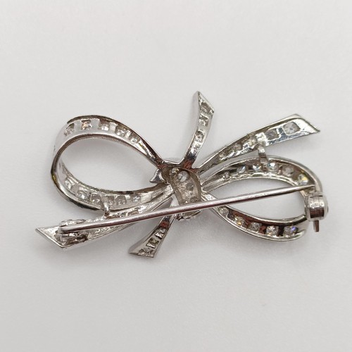 835 - An 18ct white gold and diamond bow brooch, in a vintage jewellery box