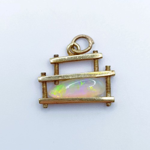 833 - A modern yellow metal and opal pendant