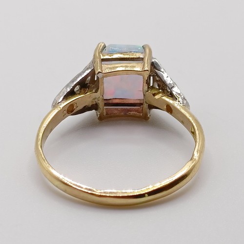 810 - A yellow metal and opal ring, with diamond shoulders, ring size M