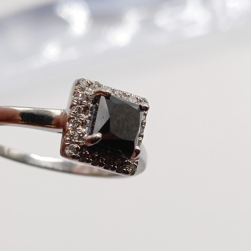 675 - A certificated platinum ring, set with square cut black diamond and a halo of RBC diamonds