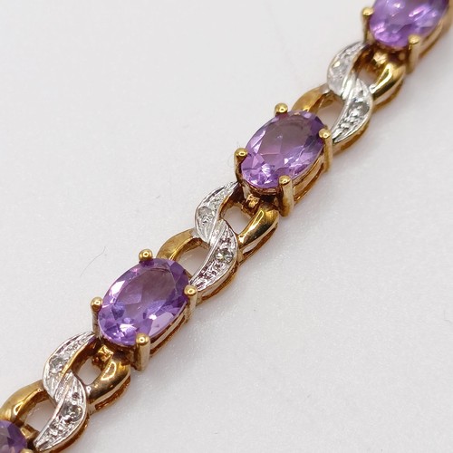 691 - A 9ct yellow gold, amethyst and diamond figure-of-eight bracelet, boxed