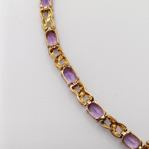 691 - A 9ct yellow gold, amethyst and diamond figure-of-eight bracelet, boxed