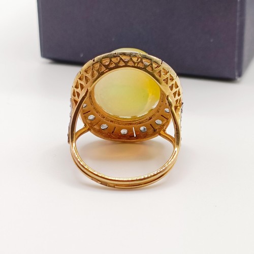 674 - A large 14ct yellow gold and silver oval cabochon Ethiopian opal and rose-cut diamond halo cocktail ... 