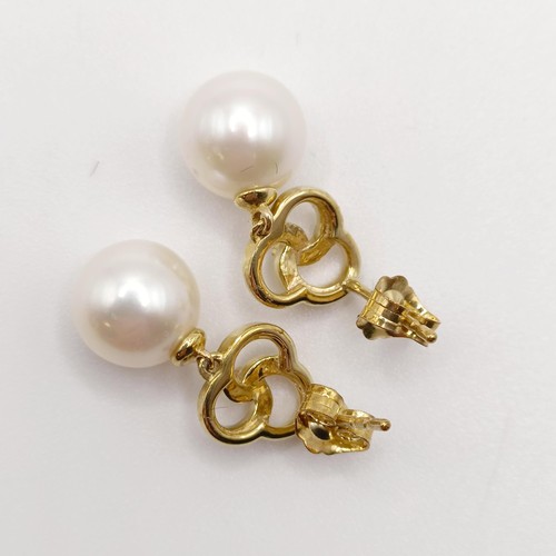 717 - A pair of 9ct yellow gold, round freshwater pearl and diamond pinwheel earrings, boxed