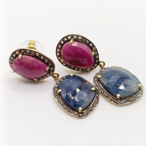 761 - A large pair of articulated drop earrings, set with large red and blue sapphires in mixed cuts, with... 