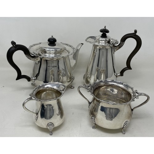 1098 - An Edward VII silver four piece tea set, comprising a hot water jug, teapot, cream jug and a sugar b... 