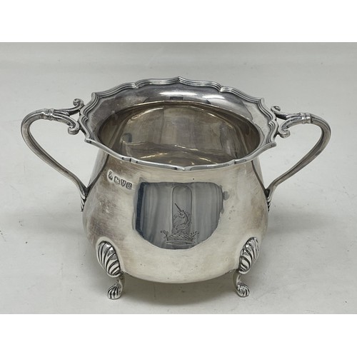 1098 - An Edward VII silver four piece tea set, comprising a hot water jug, teapot, cream jug and a sugar b... 