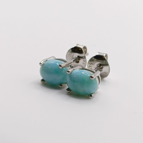 858 - A pair of cabochon larimar studs, in silver