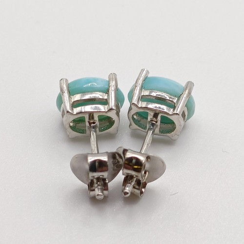 858 - A pair of cabochon larimar studs, in silver