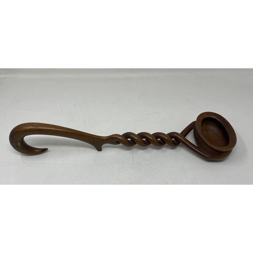 1112 - A late 18th/early 19th Century carved treen punch ladle, from a single piece of wood, the bowl inset... 