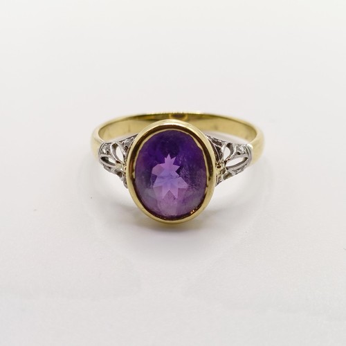 789 - A 18ct yellow gold, amethyst and rose cut diamond dress ring, with pierced design sides