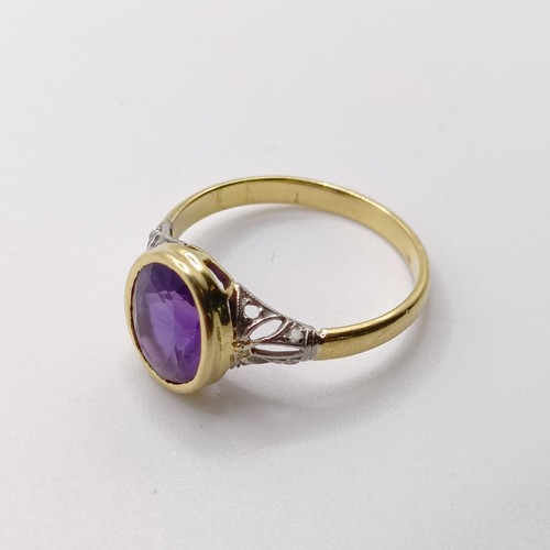 789 - A 18ct yellow gold, amethyst and rose cut diamond dress ring, with pierced design sides