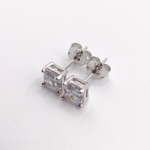 829 - A pair of princess cut CZ studs, in silver