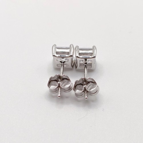 829 - A pair of princess cut CZ studs, in silver