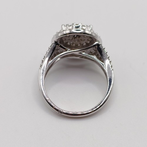 817 - A diamond cluster ring, set in 9ct white gold, with split shoulders R/C diamonds