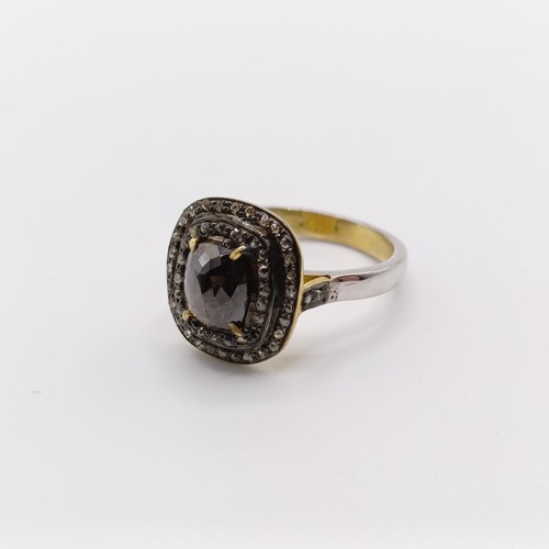 802 - A silver gilt dress ring, set with a central fancy brown rose cut cushion shaped diamond, and two ha... 