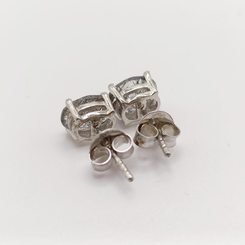 857 - A pair of rutilated quartz studs, in silver