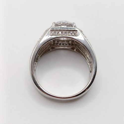 760 - A large silver gent's dress ring, set with white cubic zirconia