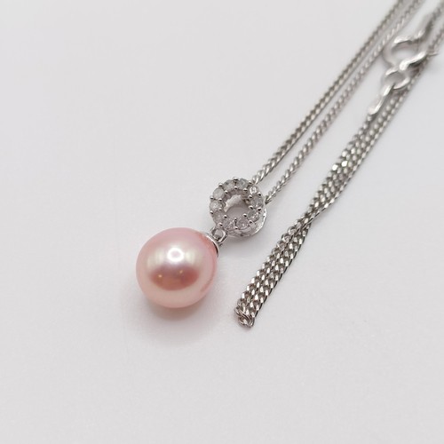 735 - A 9ct white gold, oval pink pearl and diamond halo pendant on a silver chain