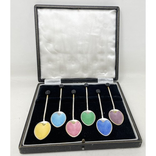 1257 - A George V set of six silver and multi-coloured enamel coffee spoons, with bean handles, cased