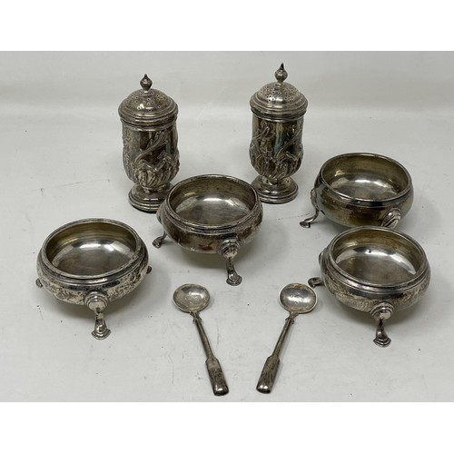 1260 - A set of four silver salts, lacking blue glass liners, a pair of salt spoons, weighable silver 6.5 o... 