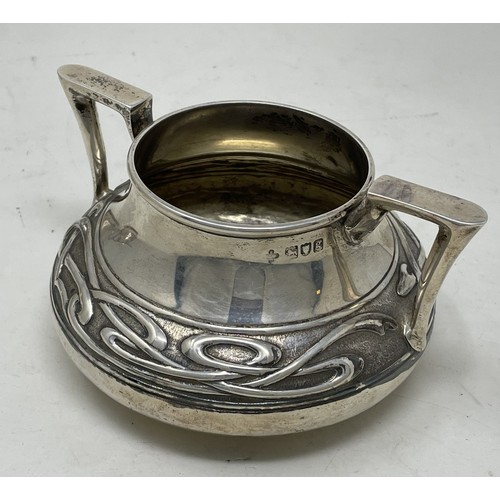 1280 - An Edward VII  Art Nouveau silver three piece tea service, comprising a teapot, sugar bowl and a cre... 