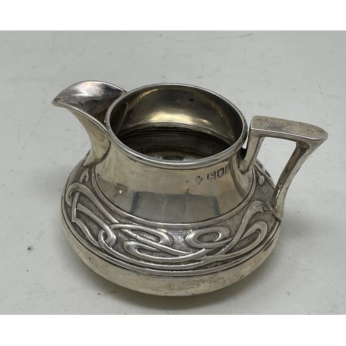 1280 - An Edward VII  Art Nouveau silver three piece tea service, comprising a teapot, sugar bowl and a cre... 