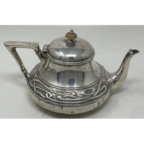 1280 - An Edward VII  Art Nouveau silver three piece tea service, comprising a teapot, sugar bowl and a cre... 