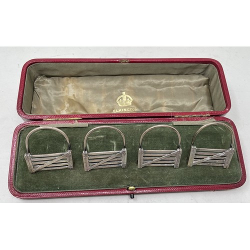 1301 - A set of four Edward VII novelty silver menu holders, in the form of five bar gates, cased, London 1... 