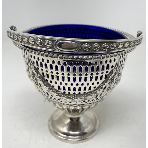 1311 - A Victorian silver swing handle sugar basket, with pierced decoration, Sheffield 1889, 5.2 ozt, with... 