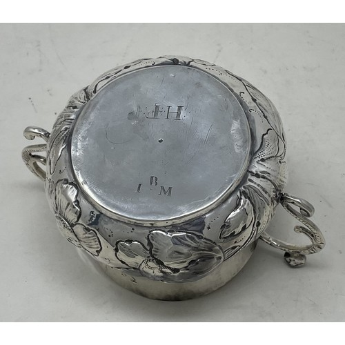 1312 - A 17th century silver porringer, engraved an armorial and with embossed decoration, 16.2 ozt, 16 cm ... 