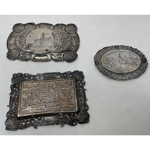 1319 - A Continental silver coloured metal tray, embossed with a building, and two others