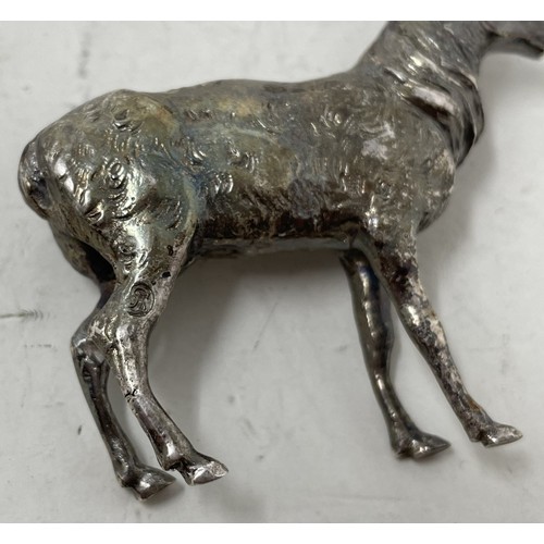 1328 - A silver coloured metal figure of a stag, 6 cm