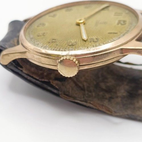 1027 - A gentleman's 9ct gold Tudor wristwatch, on a leather strap