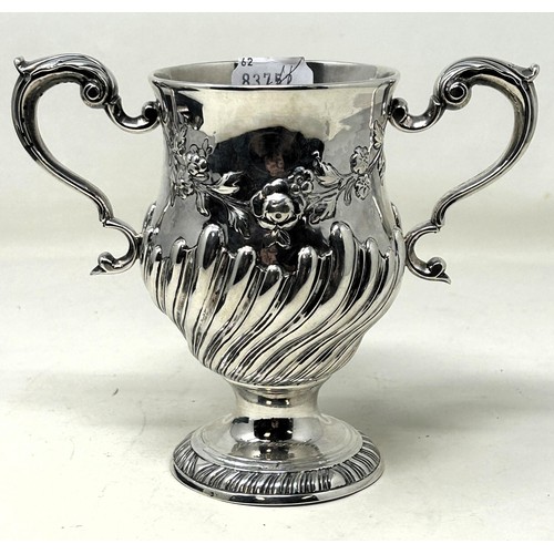 1304 - A 19th century Irish silver two handled cup, with embossed decoration, marks rubbed, 13.9 ozt, 15 cm... 