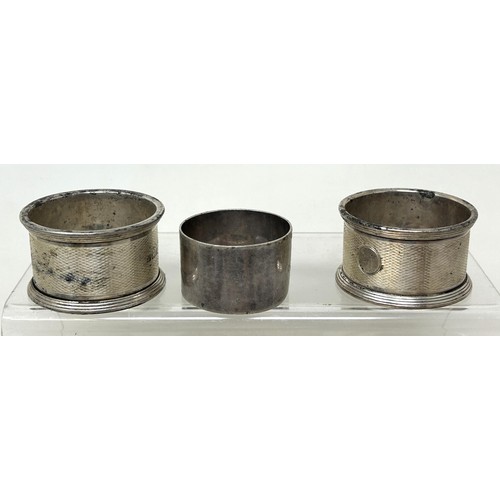 1340 - Five silver napkin rings, a silver strainer, and a silver dish, various dates and makers, 7.8 ozt