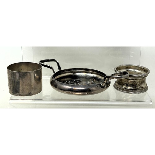 1340 - Five silver napkin rings, a silver strainer, and a silver dish, various dates and makers, 7.8 ozt