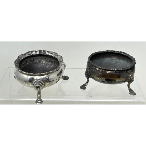 1342 - A pair of George III silver salts, on three pad feet, marks indistinct, another similar, and another... 