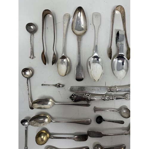 1344 - A group of silver mustard, tea, other spoons and small items of silver