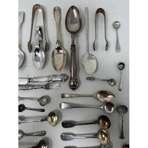 1344 - A group of silver mustard, tea, other spoons and small items of silver