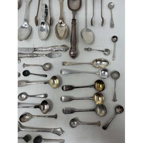 1344 - A group of silver mustard, tea, other spoons and small items of silver