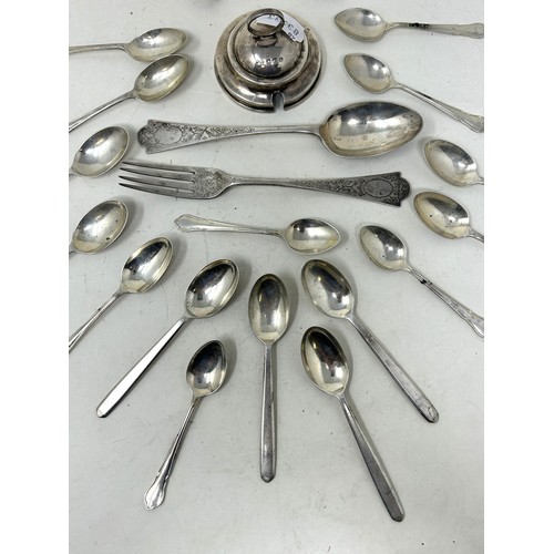 1345 - A group of assorted silver tea and coffee spoons, a silver lid, and a silver christening fork and sp... 