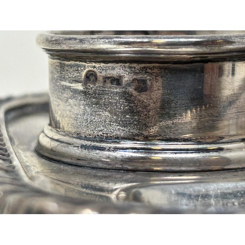 1350 - A George IV silver inkstand, with a taperstick, London 1824, lacking inkwells, 16.2 ozt 20 cm wide