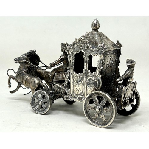 1361 - A silver group of a coach and horses, with import marks, 10 cm wide, 139 g