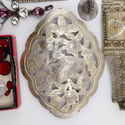 856 - A silver coloured metal buckle, decorated a bird, and assorted costume jewellery