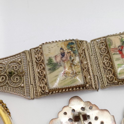 856 - A silver coloured metal buckle, decorated a bird, and assorted costume jewellery