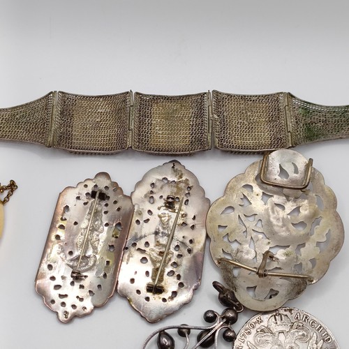 856 - A silver coloured metal buckle, decorated a bird, and assorted costume jewellery