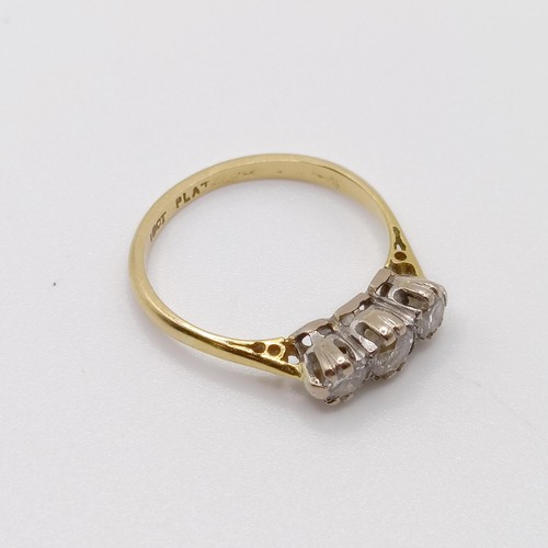 799 - An 18ct gold and three stone diamond ring, ring size M